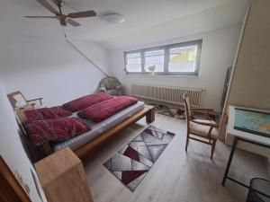 a bedroom with a bed and a desk and a window at Ferienwohnung in Dierdorf in Dierdorf