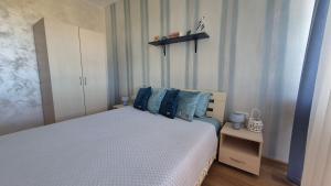 a bedroom with a bed with blue pillows at Seaside Dream in Dolen Bliznak +15 photos