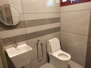 a bathroom with a toilet and a sink at Kodikkakkam Homestay in Kappil