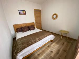 a small bedroom with a bed and a table at villa POOJA in Cap Malheureux