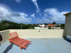 a red bench sitting on top of a roof at villa POOJA in Cap Malheureux