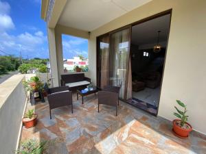 a patio with chairs and a table on a house at villa POOJA in Cap Malheureux +3 photos