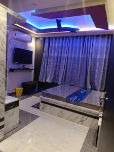 a room with a bed in front of a window at Hotel Malik Palace in Noāmundi