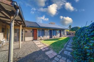 a house with a pathway leading to a yard at 13 Hobson in Secunda