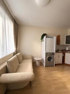a living room with a couch and a microwave at Apartment Jūros Mėlis in Nida