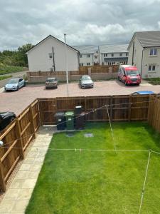 a backyard with a fence and a net at House of Berry in EDI