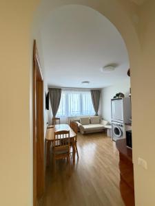 a living room with a table and a couch at Apartment Jūros Mėlis in Nida