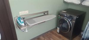 a laundry room with a washing machine and a washer at Guramishvili 7 in Kobuleti