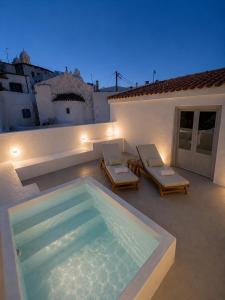 a swimming pool on the roof of a house at Dryope Luxury Living in Dhriopís