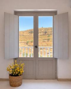 a front door with a window and a basket of flowers at Dryope Luxury Living in Dhriopís +4 photos