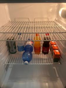 an open refrigerator filled with food and drinks at Foresteria Kiki in Gravedona