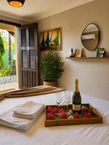 a tray with a bottle of champagne and two glasses at Alisios Kite Lodge in Cumbuco