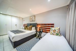 a hotel room with two beds at 13 Hobson in Secunda