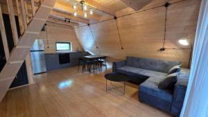a living room with a couch and a table at Riverside Ghari Cottages in Oni