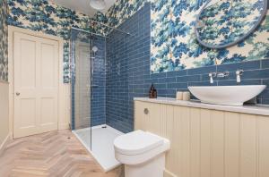 a bathroom with a toilet and a sink and a mirror at West End Townhouse in Edinburgh +36 photos