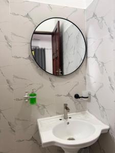 a bathroom with a sink and a mirror at Ebruli Guest House in Nungwi +85 photos