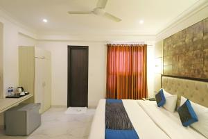 a hotel room with a bed and a window at Hotel Almora Suites - Near Delhi Airport in New Delhi +72 photos