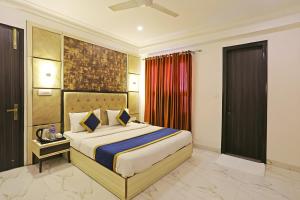 a bedroom with a large bed in a room at Hotel Almora Suites - Near Delhi Airport in New Delhi