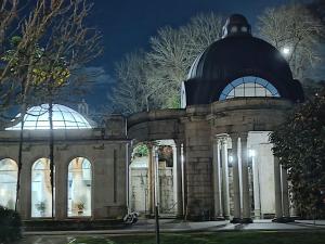 a building with two domes on top at night at Catalina in Mondariz