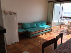 a living room with a couch and a table at Dúplex Frente Mar na ilha de Itaparica in Vera Cruz de Itaparica