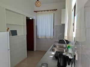 a kitchen with a sink and a counter top at Cleopatra Apartments in Laganas