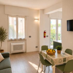 a living room with a table with a bowl of fruit on it at Bolle Apartment Monterosso al mare in Monterosso al Mare