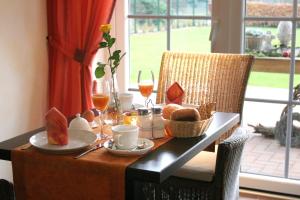 a dining room table with food and drinks on it at Hotel Landhaus Garni in Fockbek