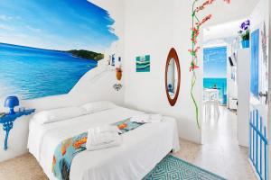 a white bedroom with a view of the ocean at Casa Nettuno in Ostuni +15 photos