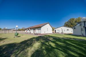 a large yard with a building in the background at 16 Vaalrivier in Secunda