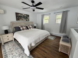 a bedroom with a bed and a ceiling fan at Poconos Hideaway in Greentown +35 photos