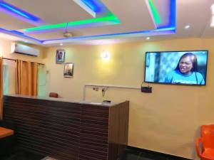 a tv on the wall of a room at Naira and Kobo Hotel in Umuahia