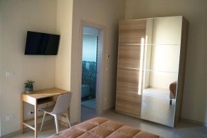 a bedroom with a bed and a desk and a sliding door at Masseria Marchesani in Montenero di Bisaccia