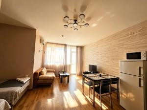 a small room with a bed and a table and a couch at Europroperties Yalta Apartments in Golden Sands