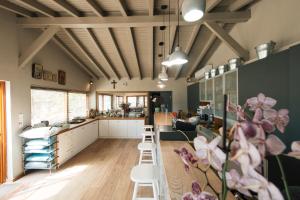 a room with tables and chairs and a kitchen at Ariadnes Holiday Accommodation in Apidias Lakos