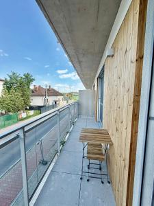 a bench on the balcony of a building at Ager Apartments Poprad in Poprad