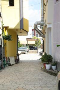 a street with a car parked in a parking lot at Prim Guest House in Këlcyrë