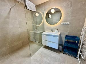 a bathroom with a sink and a mirror at Ager Apartments Poprad in Poprad +31 photos
