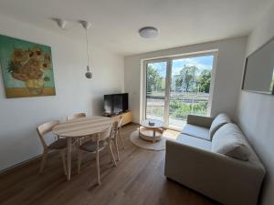 a living room with a couch and a table at Ager Apartments Poprad in Poprad