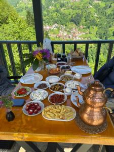 a table with plates of food on a balcony at Varya Tatil Köyü in Çamlıhemşin +32 photos