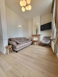 a living room with a couch and a fireplace at Castle-grounds house with rooftop view & jacuzzi in Ghent