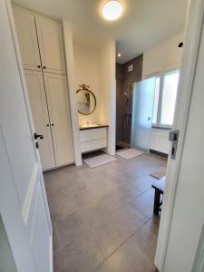 a bathroom with a sink and a mirror at Castle-grounds house with rooftop view & jacuzzi in Ghent +42 photos