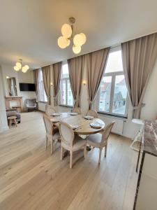 a dining room with a table and chairs at Castle-grounds house with rooftop view & jacuzzi in Ghent