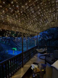 a deck with lights and a hammock on it at BrusNica in Gornji Milanovac