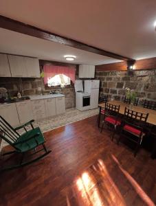 a kitchen and dining room with a table and chairs at BrusNica in Gornji Milanovac