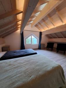 a bedroom with a large bed and a window at La remise de Saussenigoutte in Cornimont