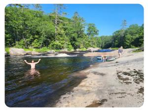 a man standing in the water at a beach at Flatrock on the River Topknot in Frankfort