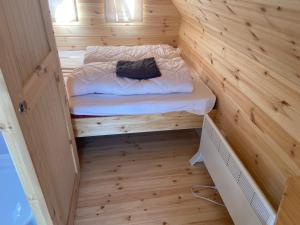 a small room with a bed in a wooden wall at Rustical deluxe - Hexenhäuschen in Echternacherbrück +11 photos