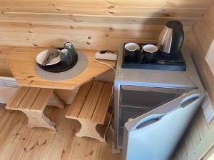 a tiny kitchen with a table and a stove at Rustical deluxe - Hexenhäuschen in Echternacherbrück