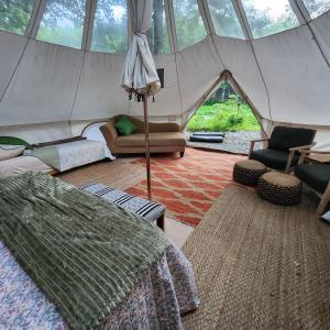a room with a tent with a couch and chairs at Flatrock on the River Topknot in Frankfort