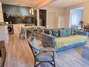a living room with a couch and a table with chairs at Lazy Tilapia in Baie du Tombeau